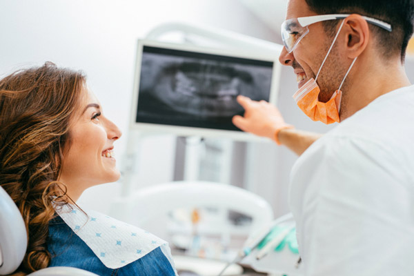 Patient and doctor looking at dental x-ray